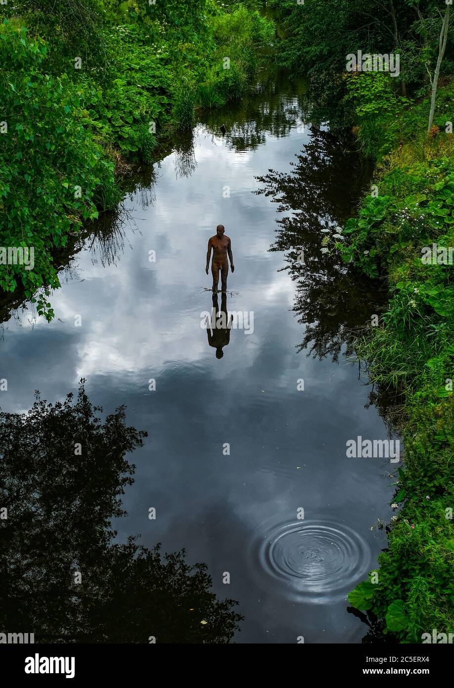 Antony Gormley sculpture in the Water of Leith at Canonmills, Edinburgh. Stock Photo