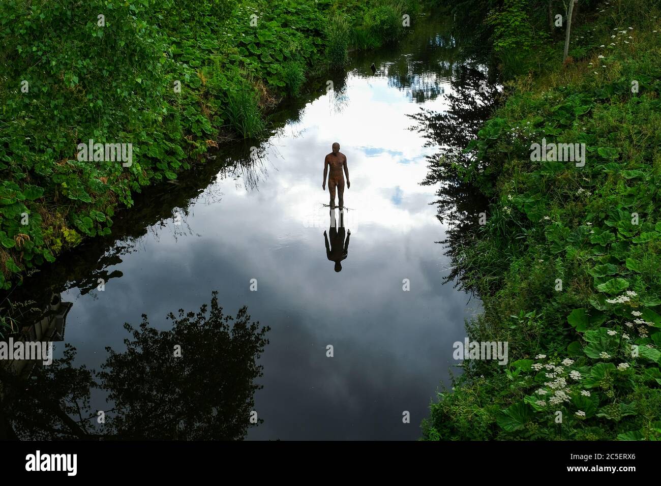Antony Gormley sculpture in the Water of Leith at Canonmills, Edinburgh. Stock Photo