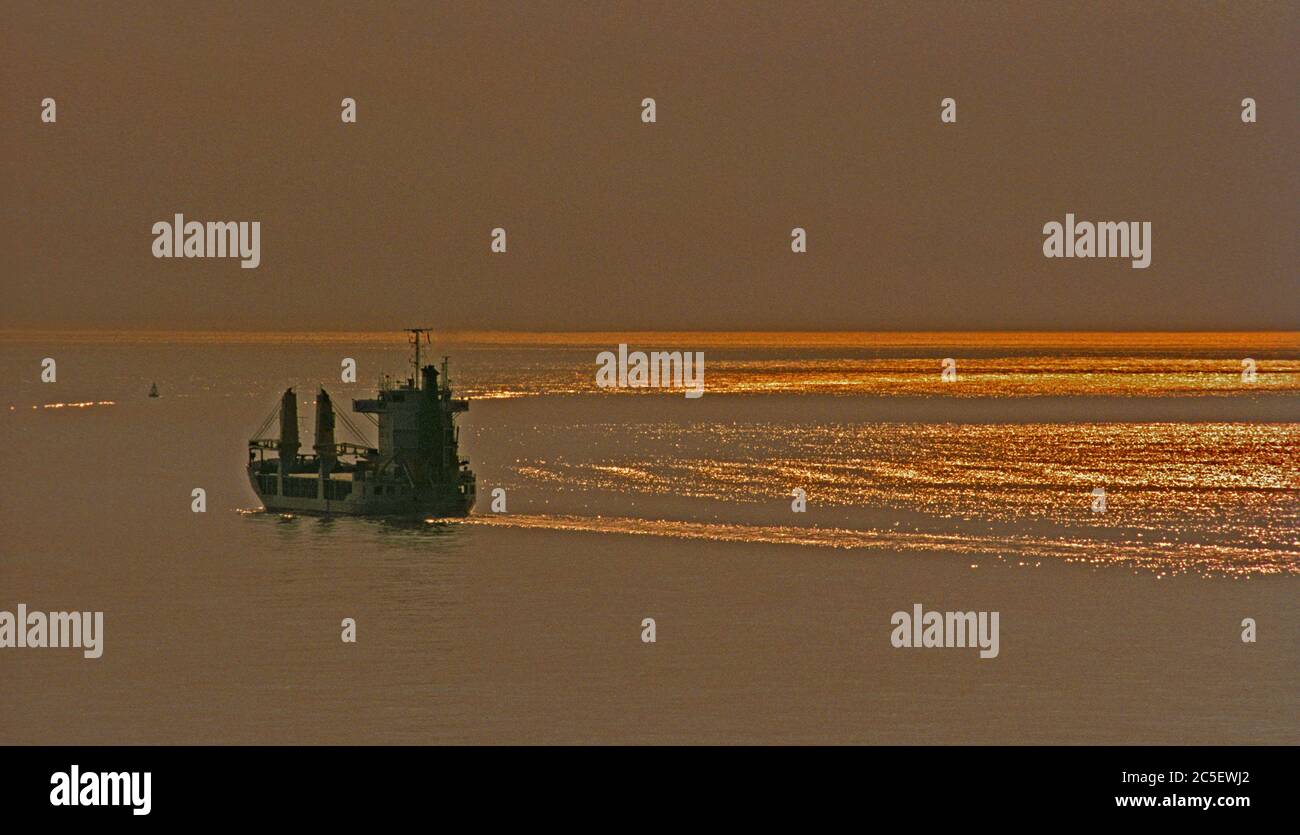 north sea, netherlands - july 29, 2004: a cargo ship outbound from antwerp making it down the river wertern scheldt estuary towards the northsea at du Stock Photo
