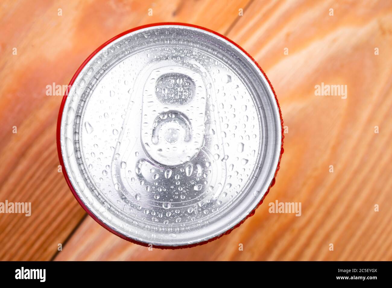 Can of soda lemonade with water drops in macro view on wood background Stock Photo