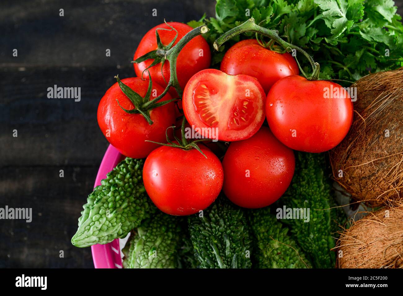 mix Vegetable .tomato, Quora ,karela, in basket on black wooden table Stock  Photo - Alamy