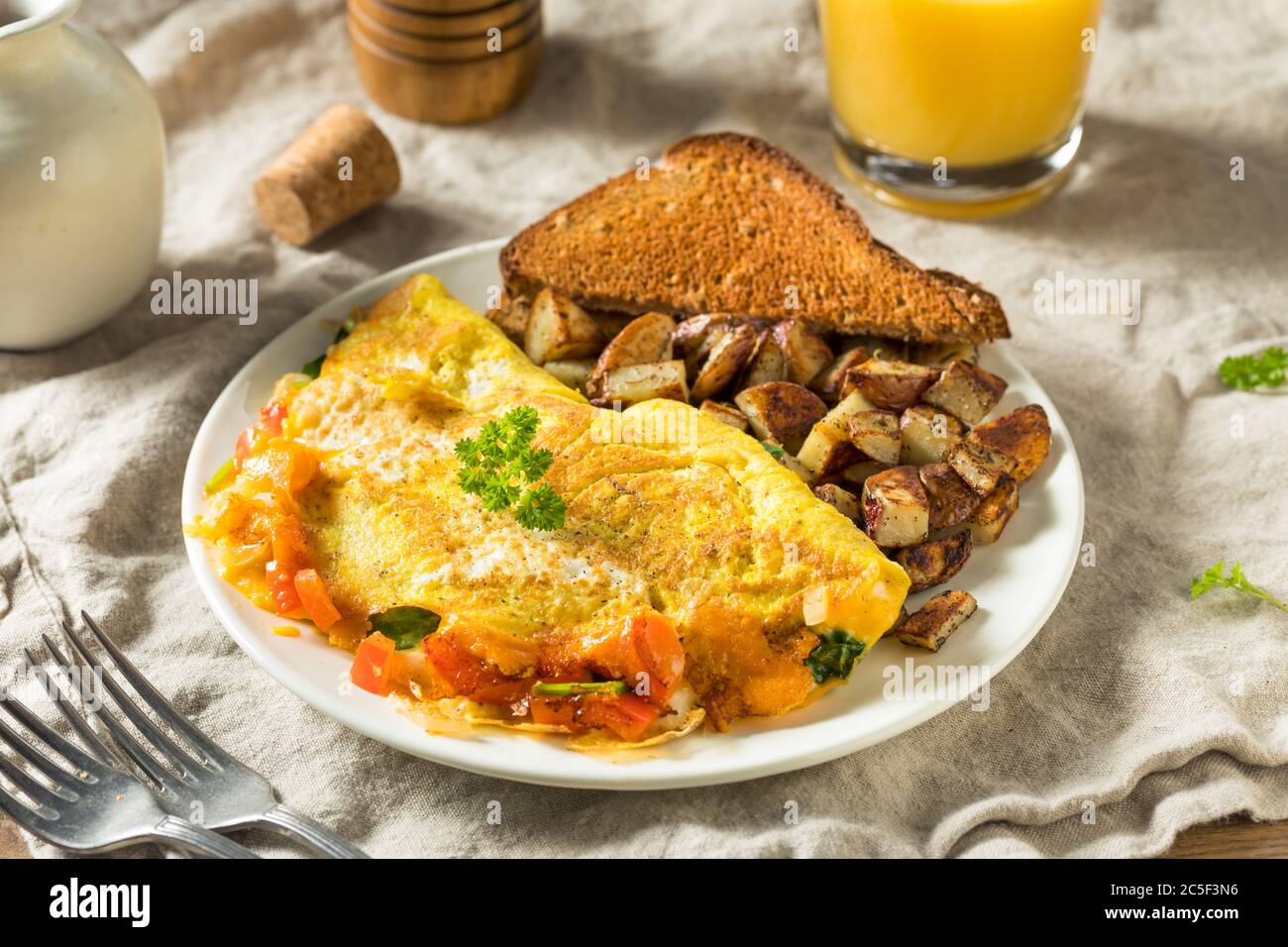 Homemade Veggie Omelette with Cheese Potatoes and Toast Stock Photo