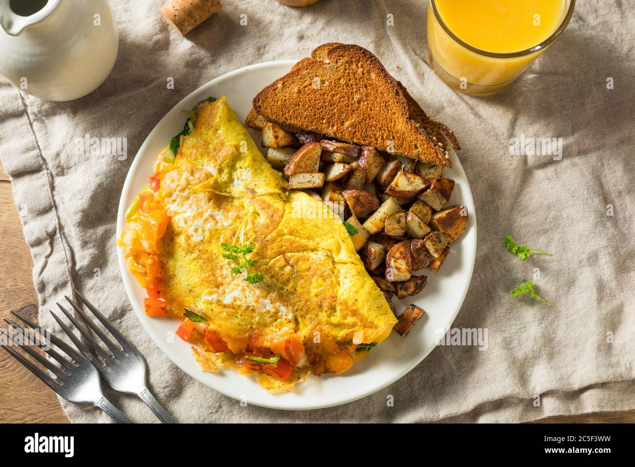 Homemade Veggie Omelette with Cheese Potatoes and Toast Stock Photo