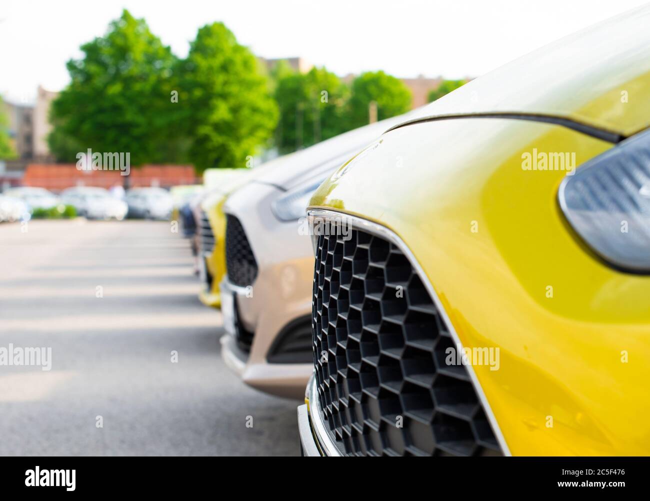 Vibrant new cars for sale stock lot row Stock Photo