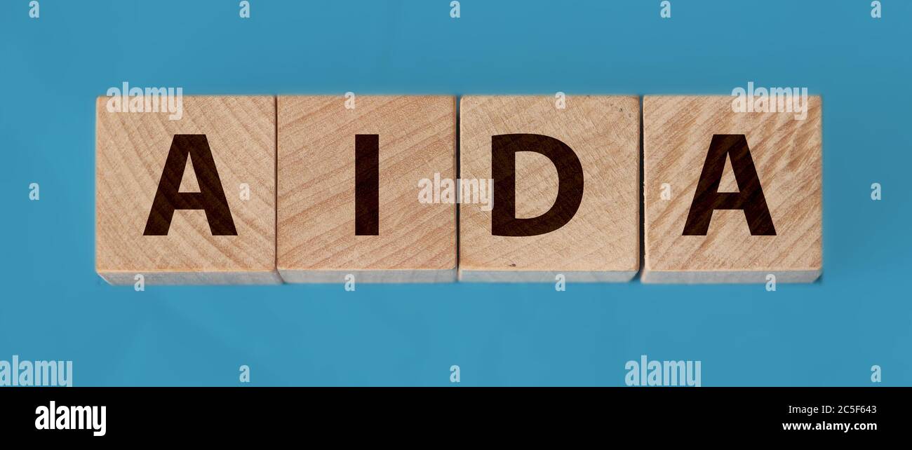 Four wooden cubes with letters AIDA meaning Attention Awareness