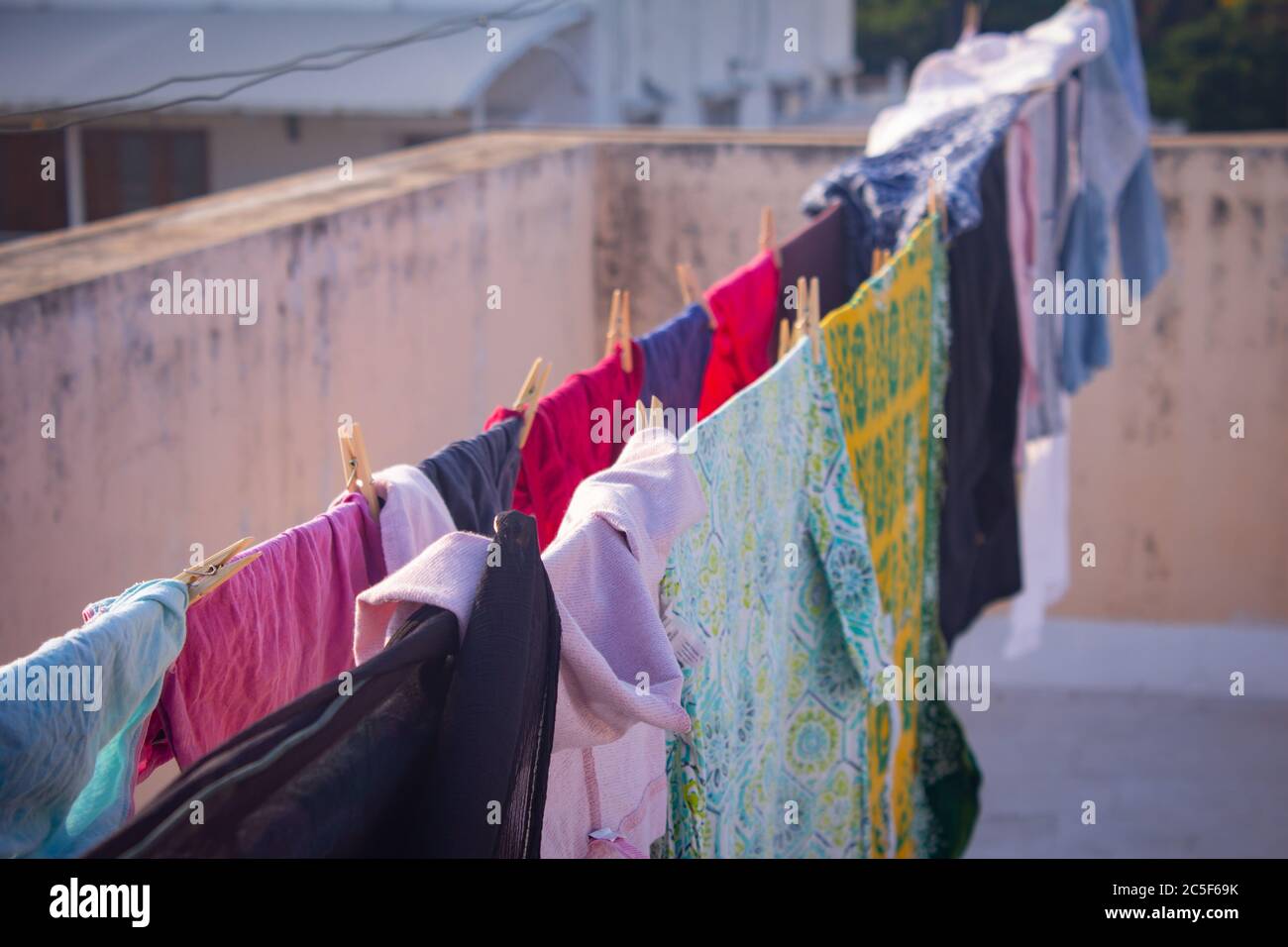 Washed clothes been dried under the sun in natural way. Stock Photo