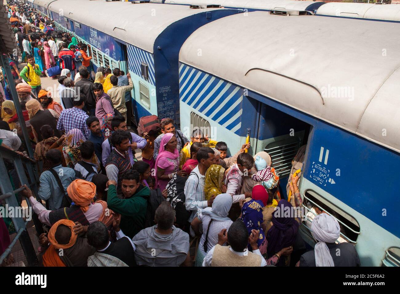 Passengers board a train at Rohtak railway station Stock Photo