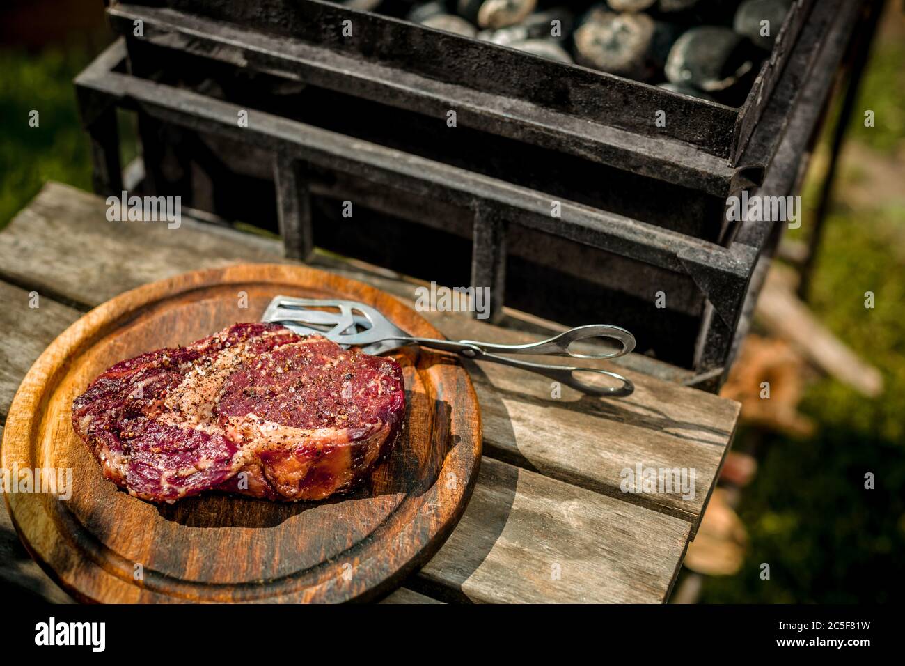 A thick strip steak being grilled outdoors Stock Photo Alamy