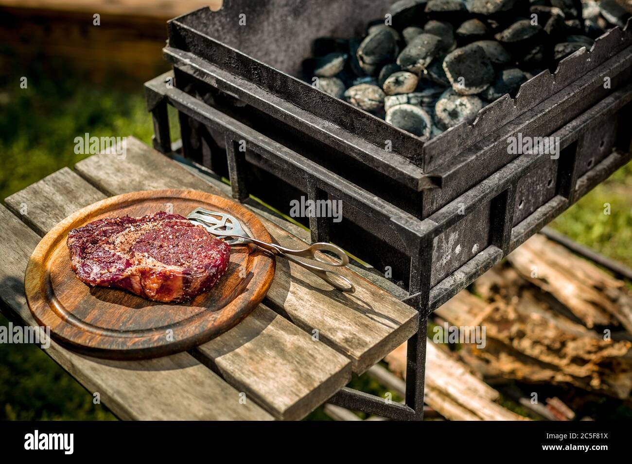 A thick strip steak being grilled outdoors Stock Photo Alamy