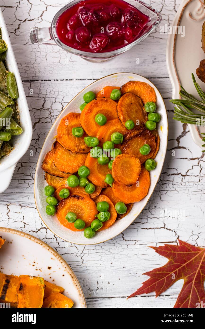 Glazed roasted carrot with peas Stock Photo Alamy