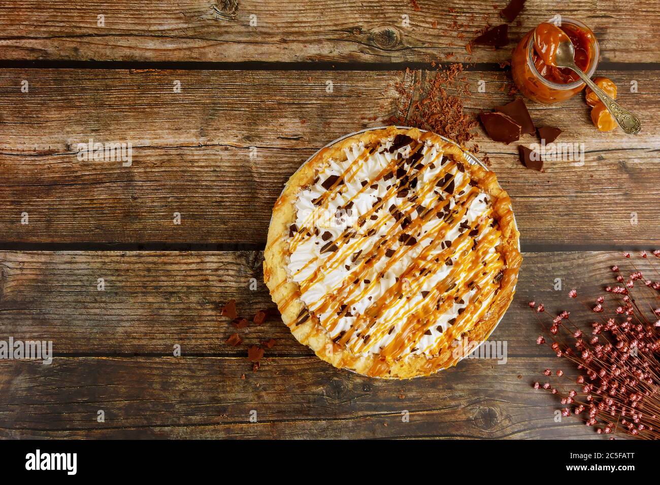Pie with whipped cream and caramel topping. Top view Stock Photo Alamy