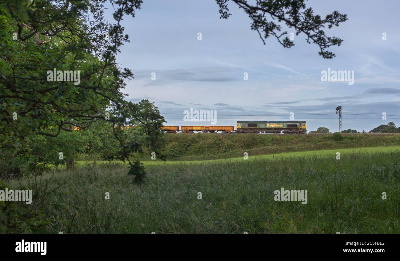 Freightliner class 66 locomotive 66604 in the countryside on the west coast mainline wit a Network Rail engineers possession train Stock Photo