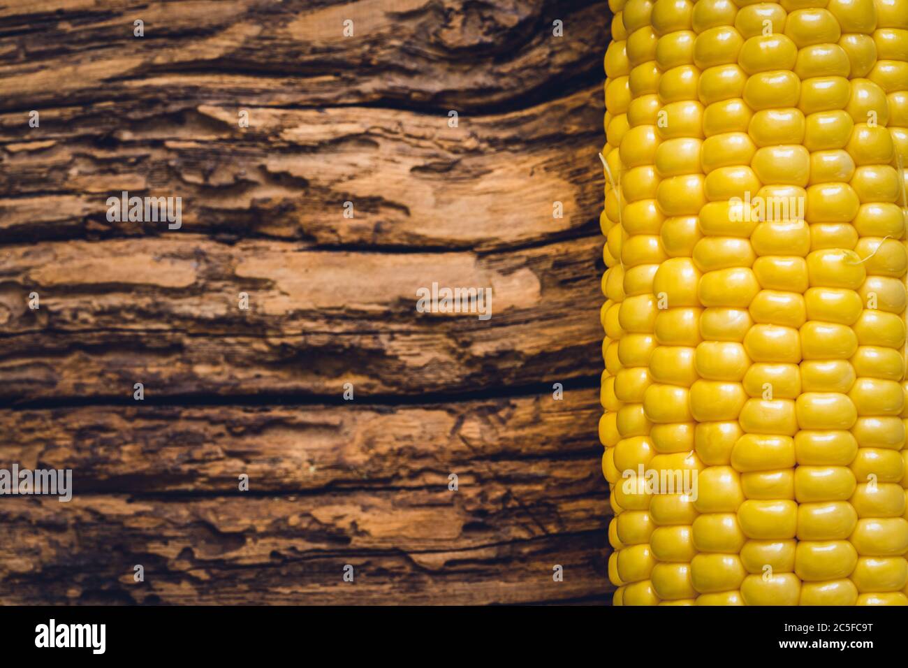 Corn isolated on wooden background Stock Photo