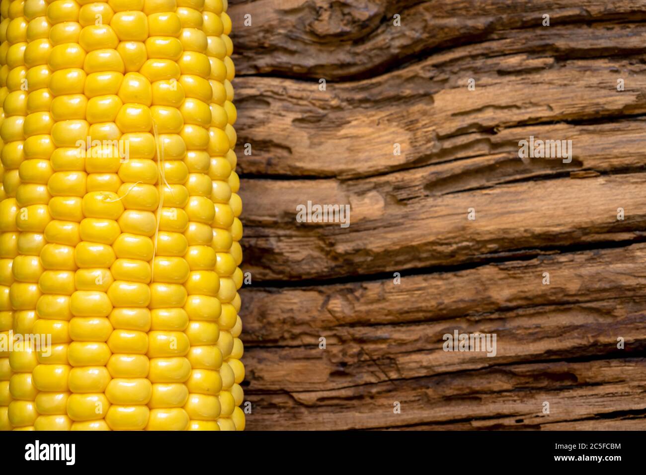 Corn isolated on wooden background Stock Photo