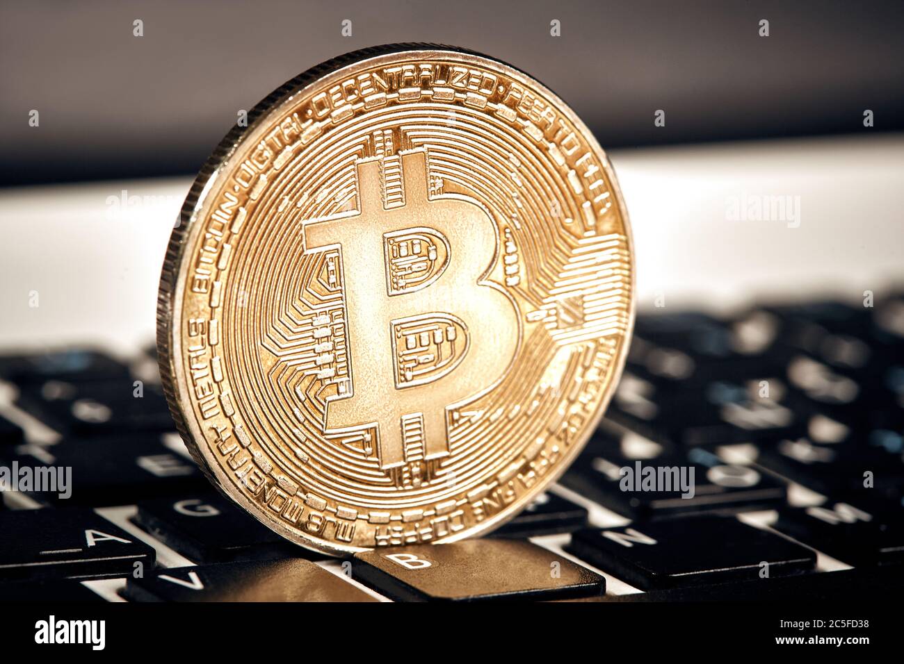 Coin crypto currency bitcoin lies on the keyboard background theme gold  exchange pyramid for money due to rise or fall exchange rate close up Stock  Photo - Alamy