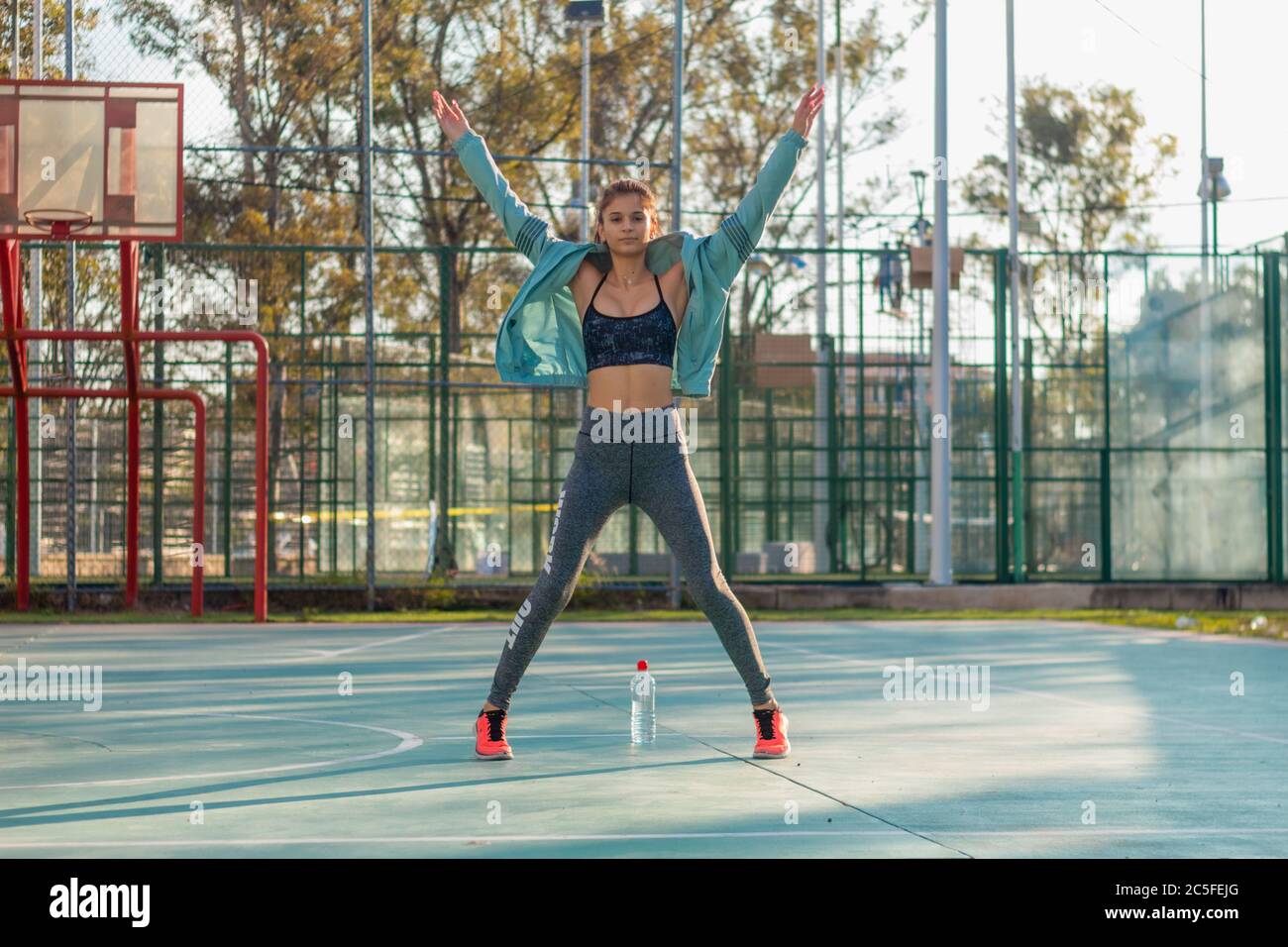 Mexican fitness girl jumping in a basketball court outdoors Stock Photo ...