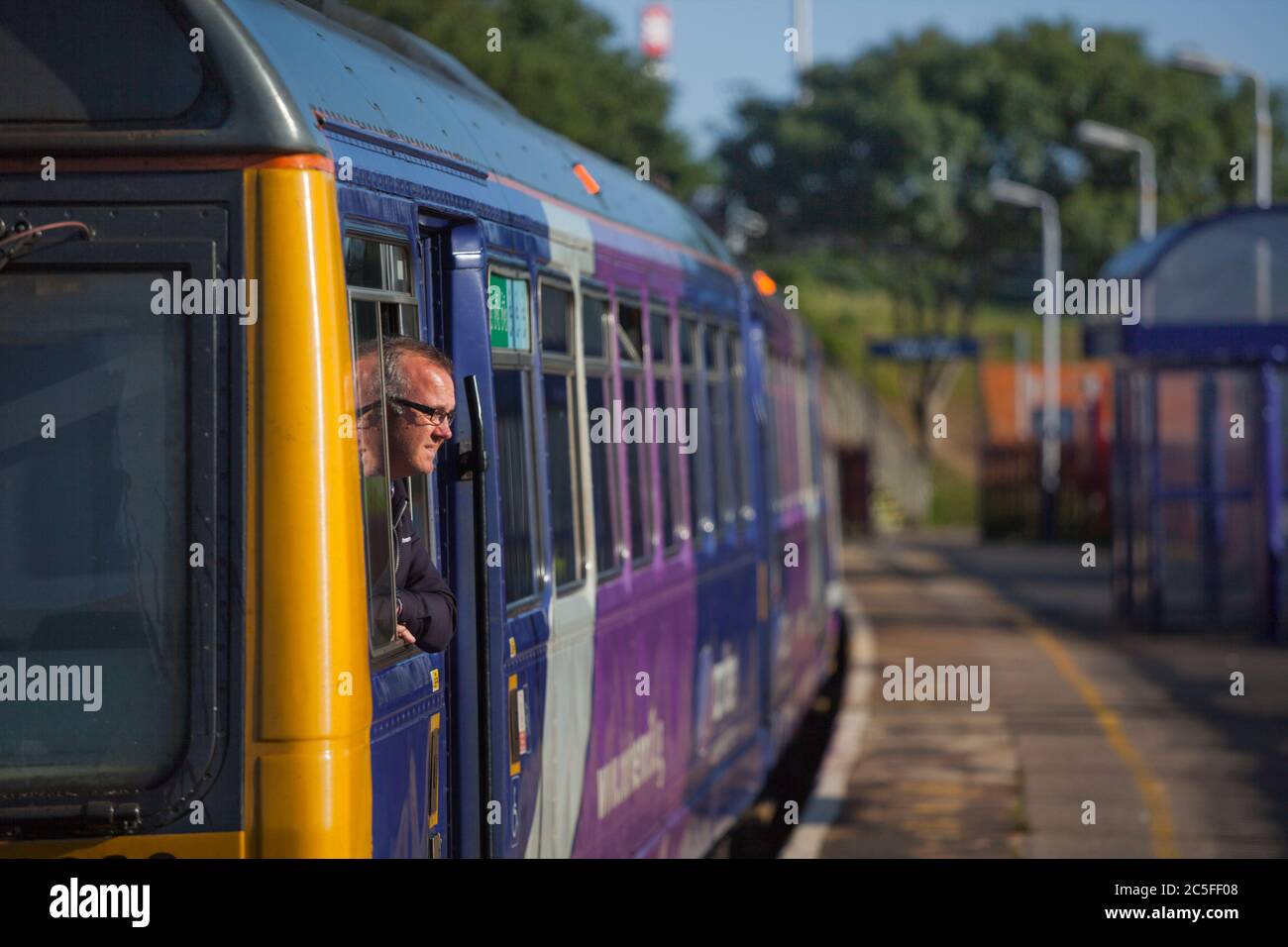 Northern Rail train driver looking out of a Northern Rail class 142 pacer train at Blackpool south railway station Stock Photo