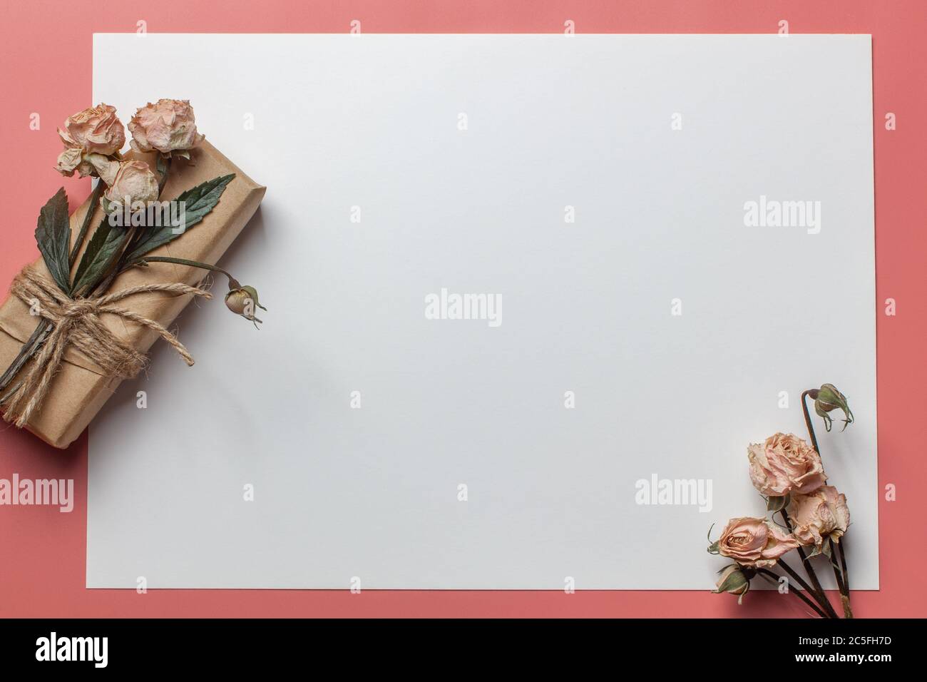 Flowers composition. Workspace with small bouquet and gift Top view, flat lay Stock Photo