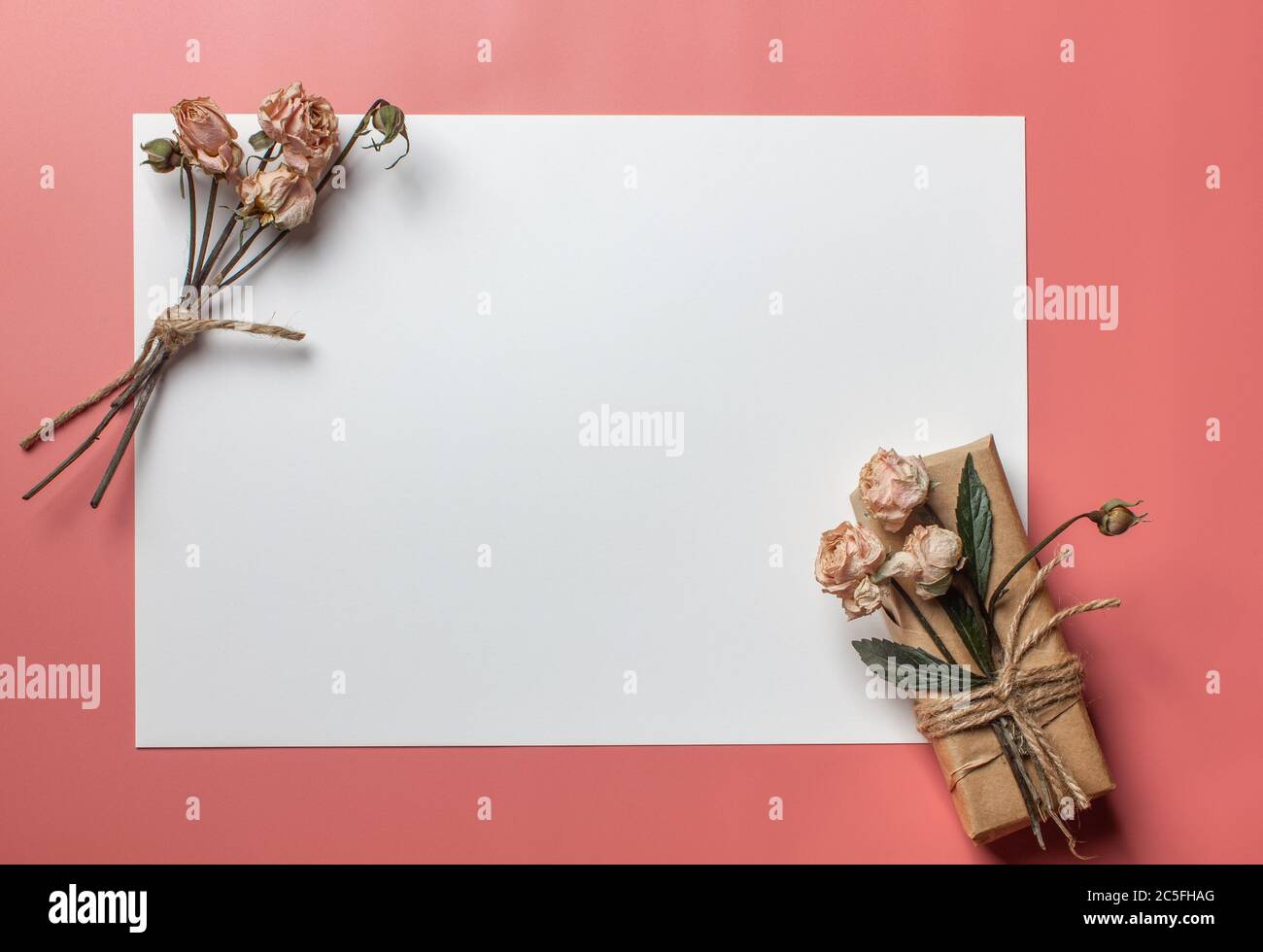 Flowers composition. Workspace with small bouquet and gift Top view, flat lay Stock Photo