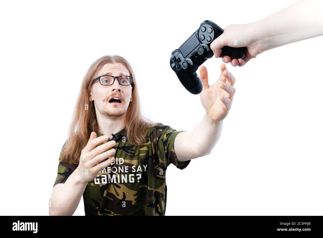 Female Takes Away Controller From Long Haired Male Gamer Stock Photo