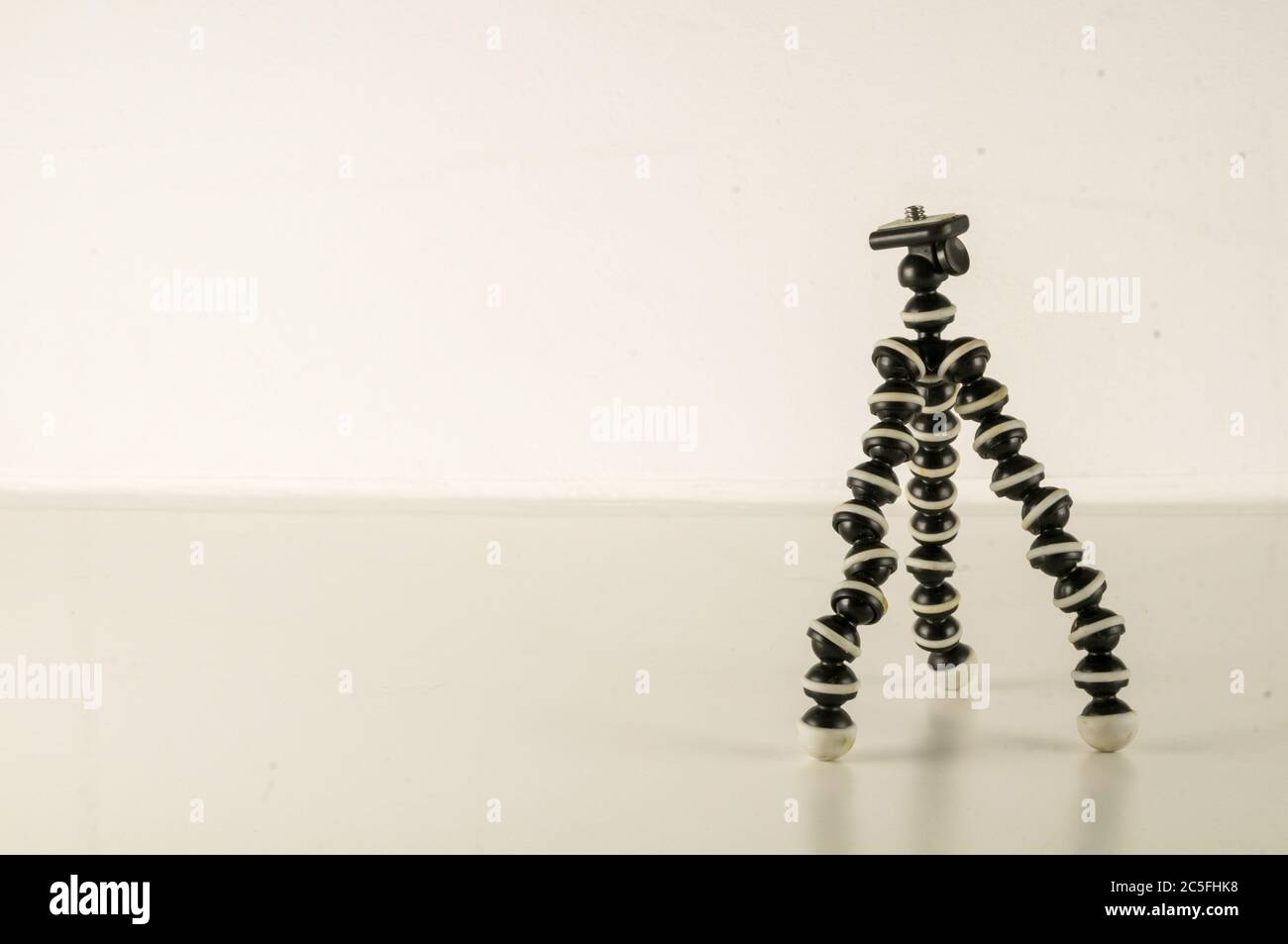 Mini table flexible tripod on white background Stock Photo