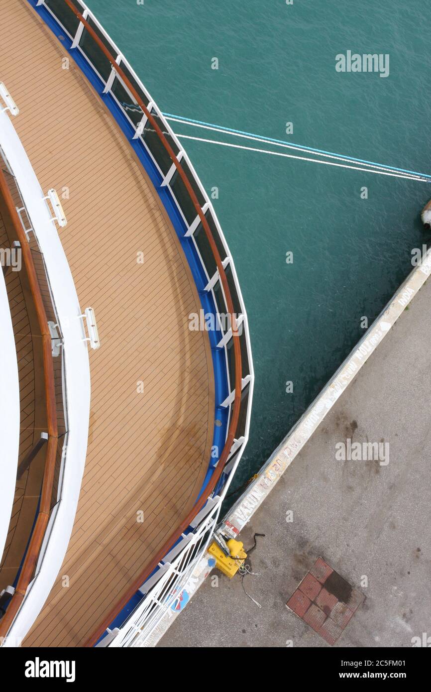 Cruise ship tied up to dock showing lower deck & pier Stock Photo Alamy