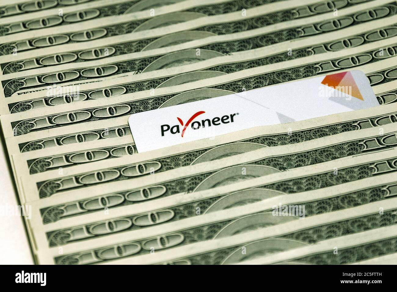 Moscow 10/03/2020 Payoneer prepaid plastic card amongst dollar bills Stock Photo
