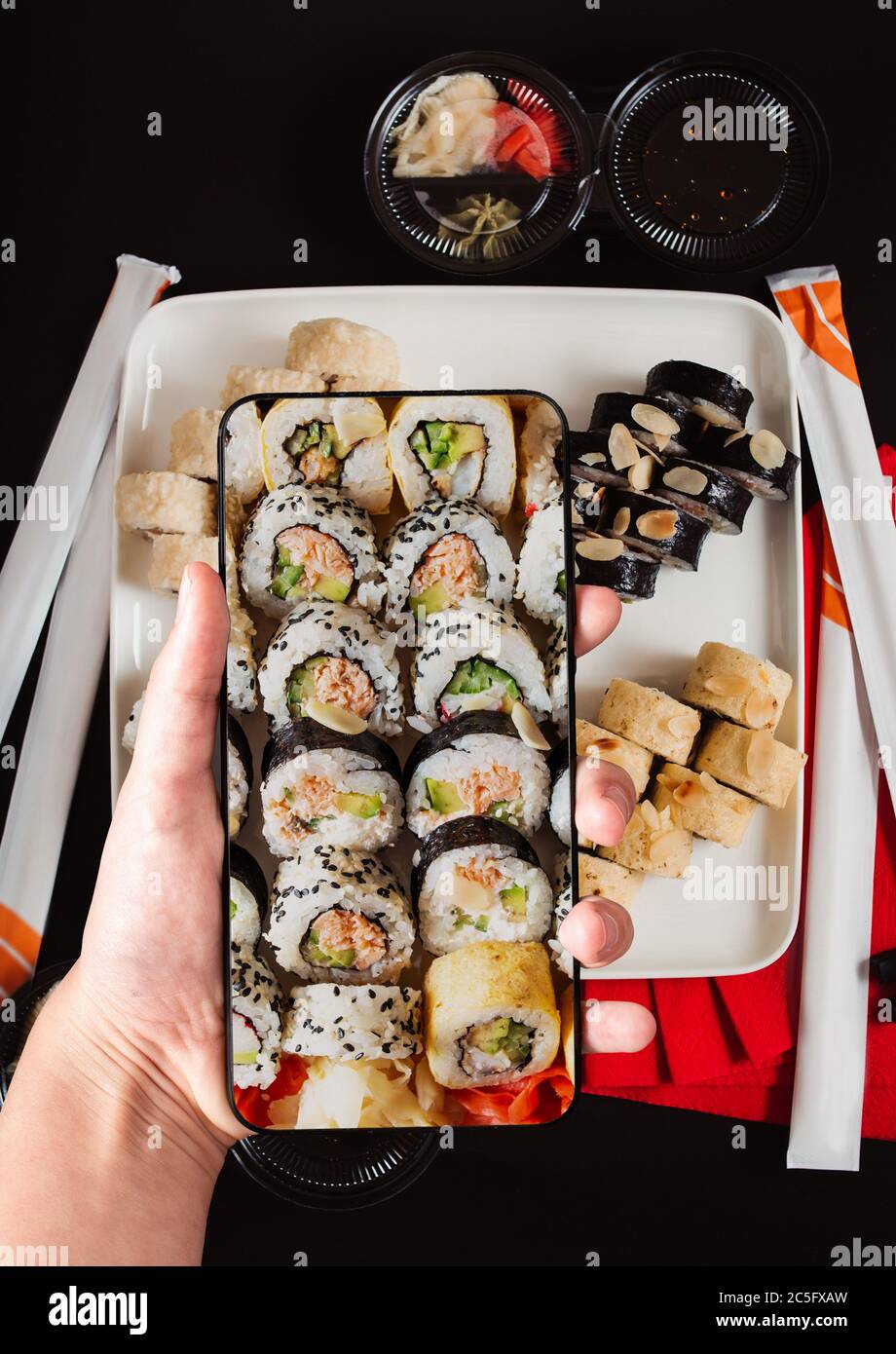 Order sushi set using mobile phone app. Online food delivery concept Stock  Photo - Alamy