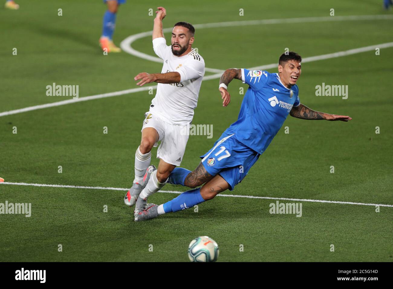 Madrid, Spain. 2nd July, 2020. Real Madrid's Dani Carvajal (L) vies with Getafe's Mathias Olivera during a Spanish league football match between Real Madrid and Getafe in Madrid, Spain, July 2, 2020. Credit: Edward F. Peters/Xinhua/Alamy Live News Stock Photo