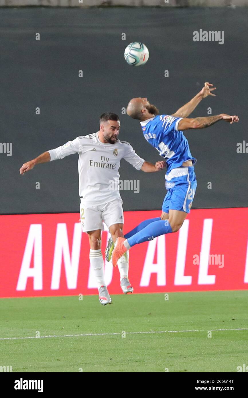 Madrid, Spain. 2nd July, 2020. Real Madrid's Dani Carvajal (L) and Getafe's David Timor vie for the ball during a Spanish league football match between Real Madrid and Getafe in Madrid, Spain, July 2, 2020. Credit: Edward F. Peters/Xinhua/Alamy Live News Stock Photo