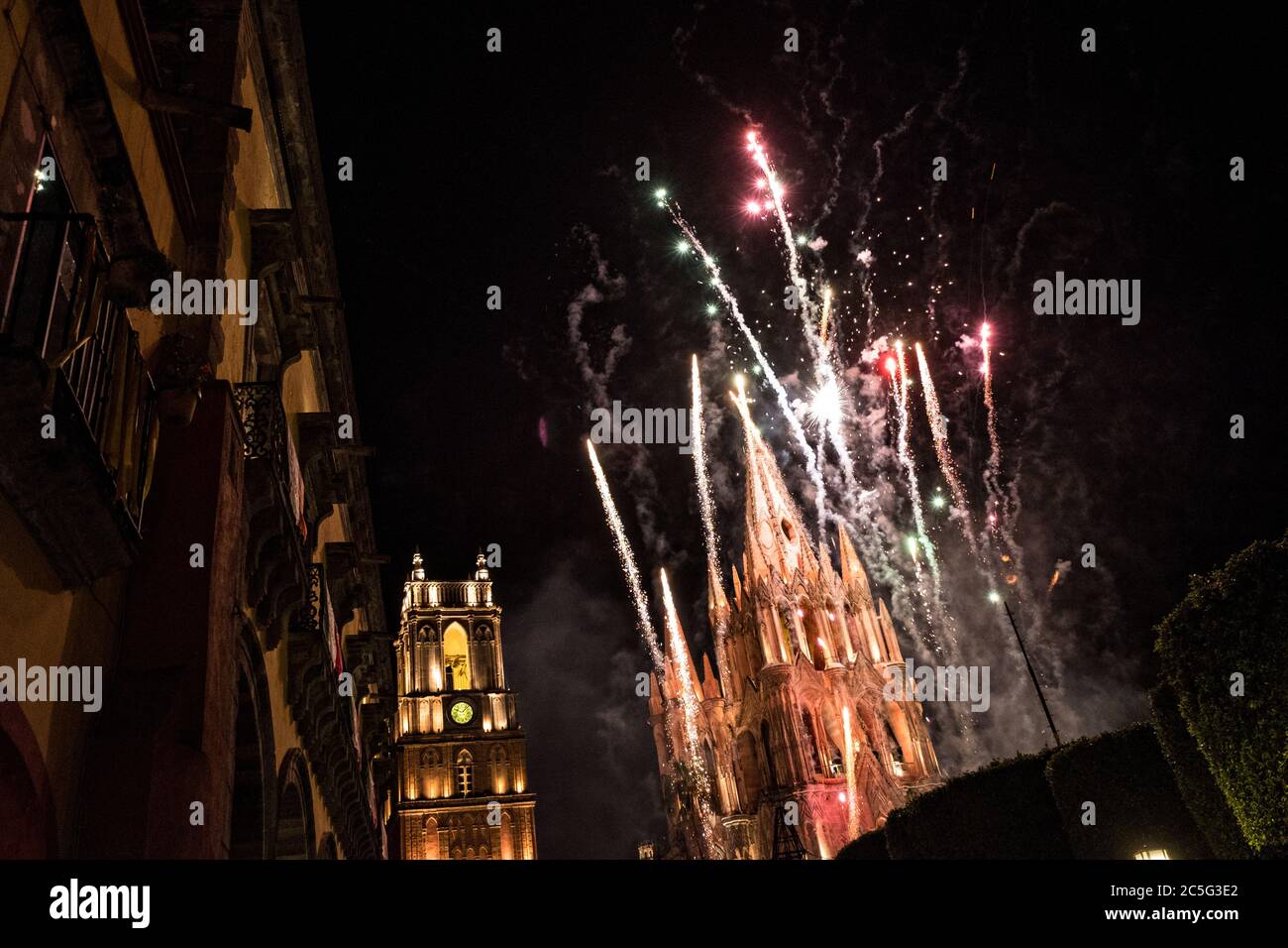 Fireworks explode over the Parroquia de San Miguel Arcangel and San Rafael Church in the Jardin Allende during the week long fiesta of the patron saint Saint Michael October 1, 2017 in San Miguel de Allende, Mexico. Stock Photo