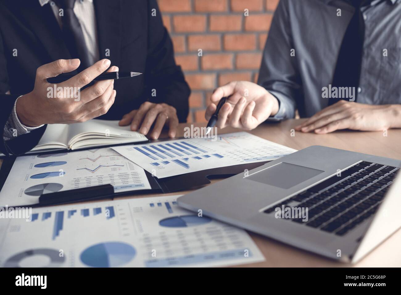 Businessman looking graph and summary report on document finance budget paper with analysis cost data result. Stock Photo