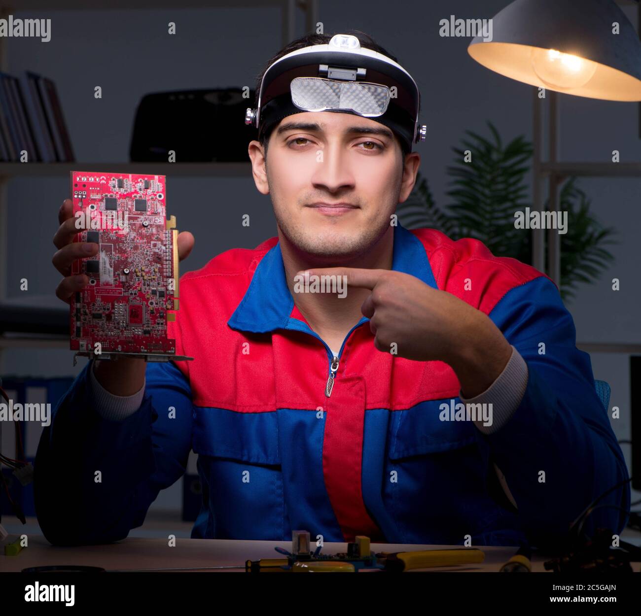 The computer specialist repairing pc late at night Stock Photo - Alamy