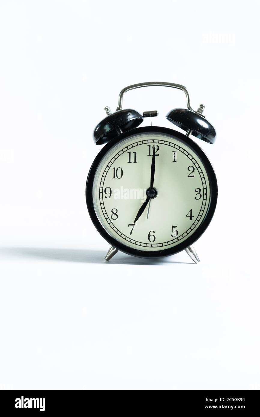 A black alarm clock isolated against white background Stock Photo - Alamy
