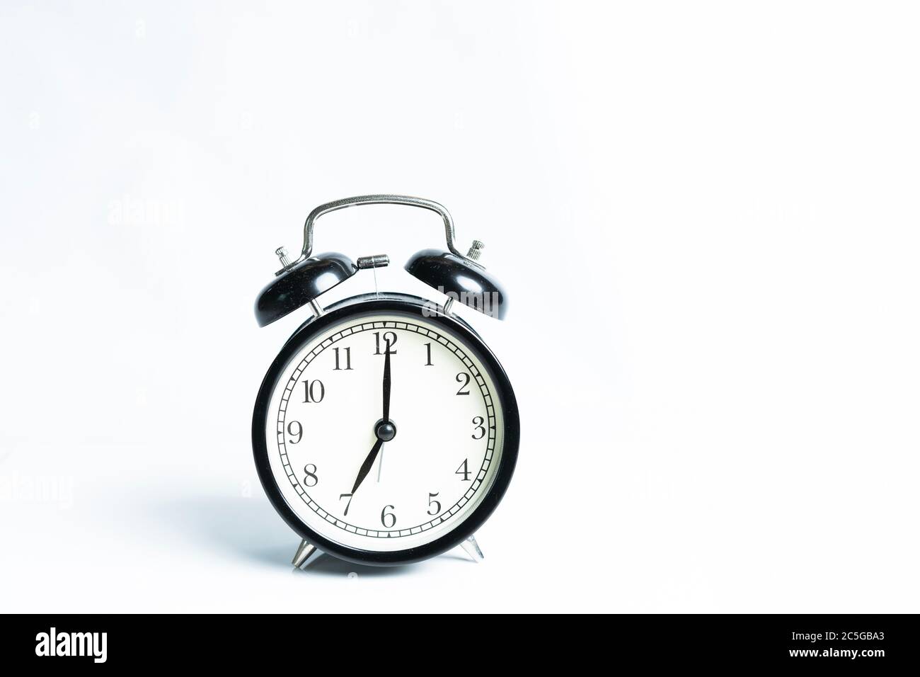A black alarm clock isolated against white background Stock Photo - Alamy
