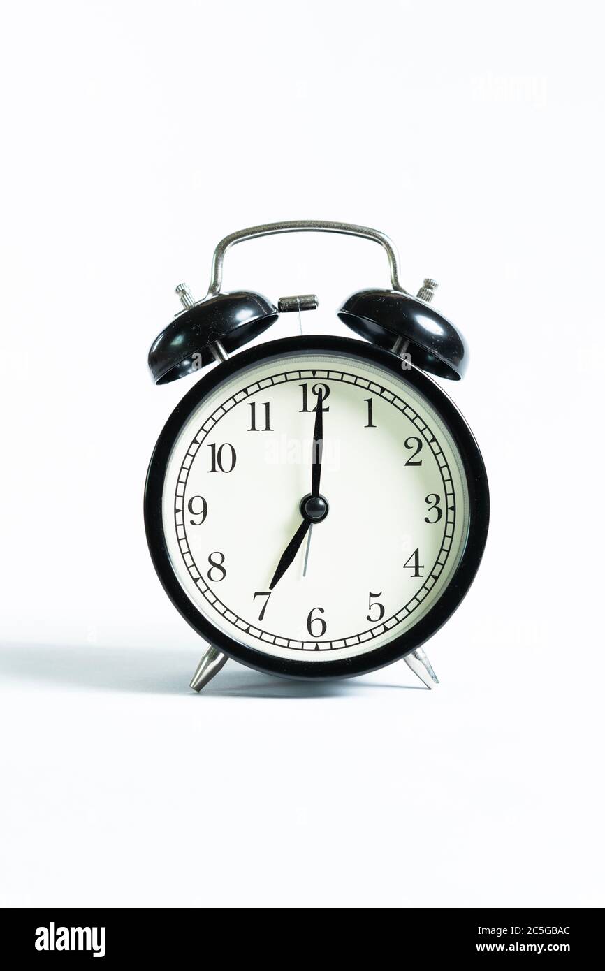 A black alarm clock isolated against white background Stock Photo - Alamy