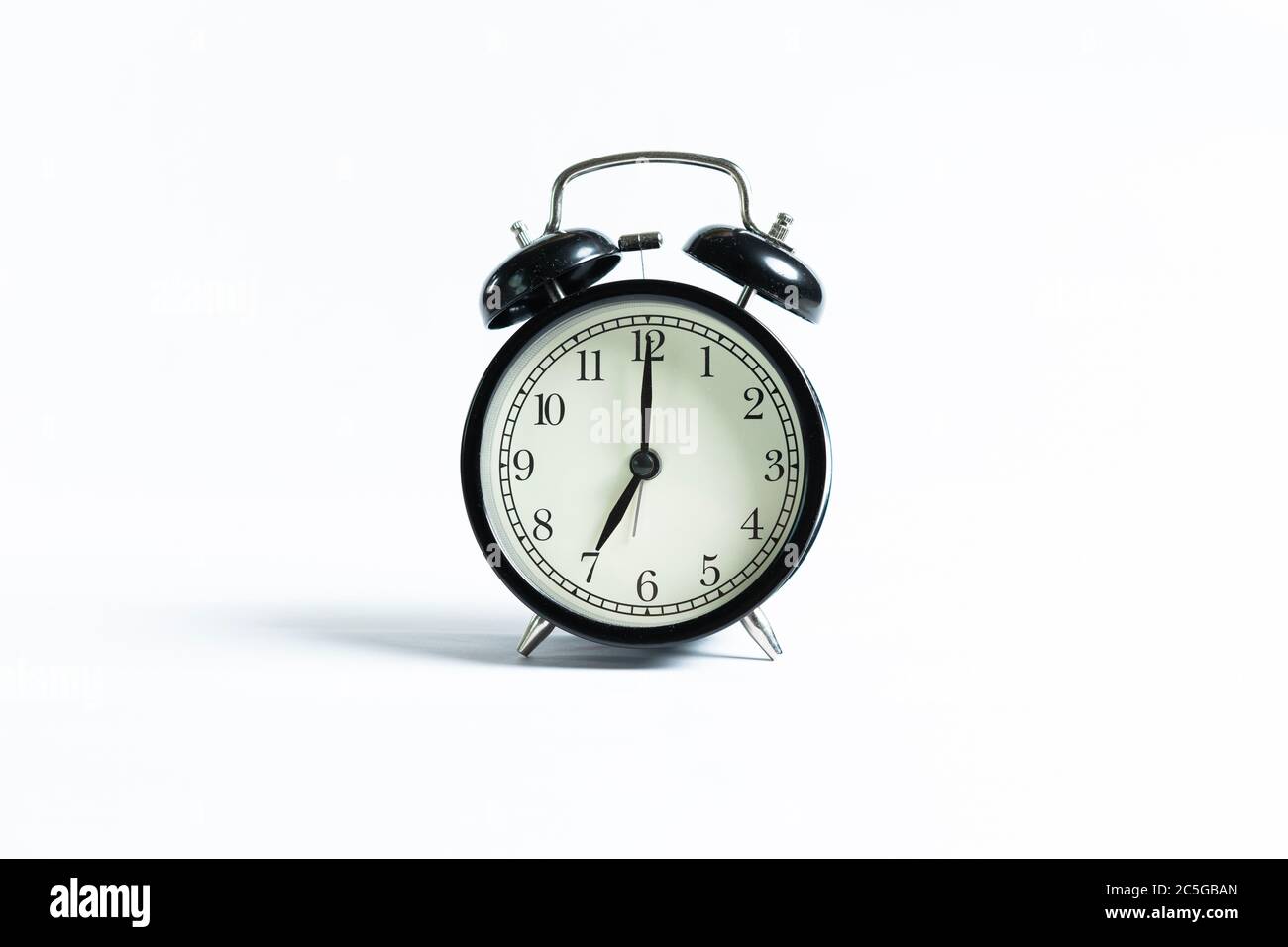 A black alarm clock isolated against white background Stock Photo - Alamy