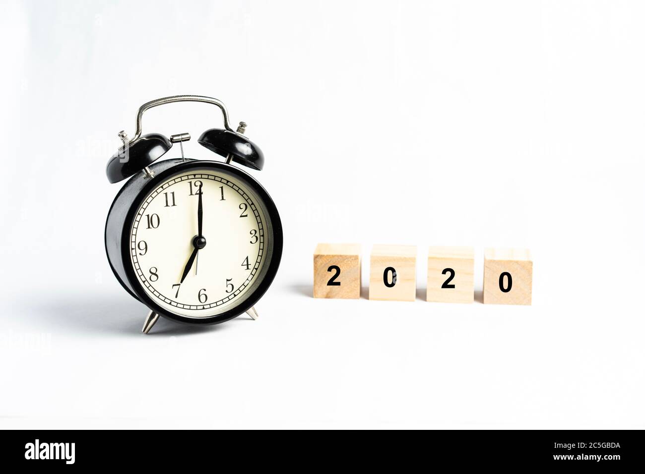 A black alarm clock isolated against white background Stock Photo - Alamy