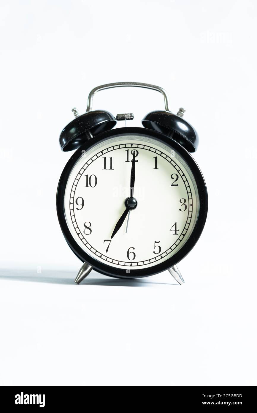 A black alarm clock isolated against white background Stock Photo - Alamy