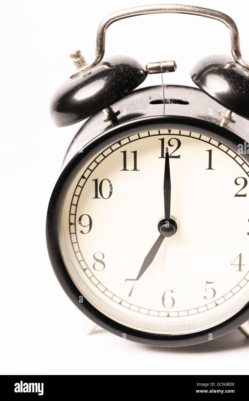 A black alarm clock isolated against white background Stock Photo - Alamy