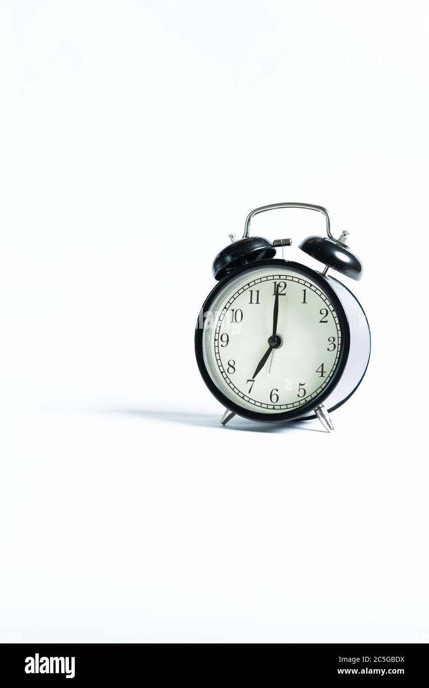 A black alarm clock isolated against white background Stock Photo - Alamy