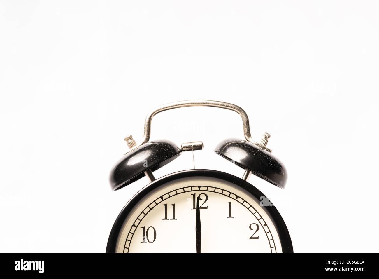 A black alarm clock isolated against white background Stock Photo - Alamy