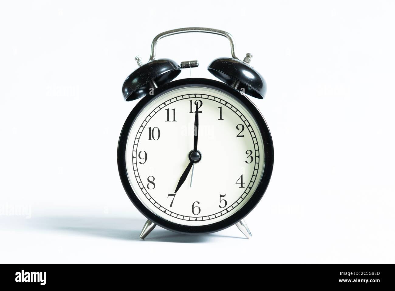 A black alarm clock isolated against white background Stock Photo - Alamy