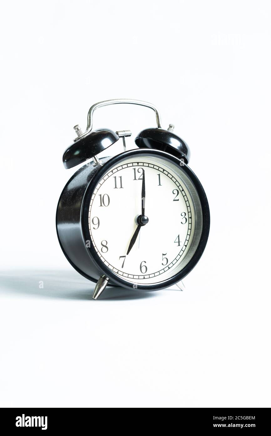 A black alarm clock isolated against white background Stock Photo - Alamy