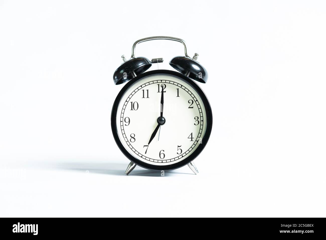 A black alarm clock isolated against white background Stock Photo - Alamy