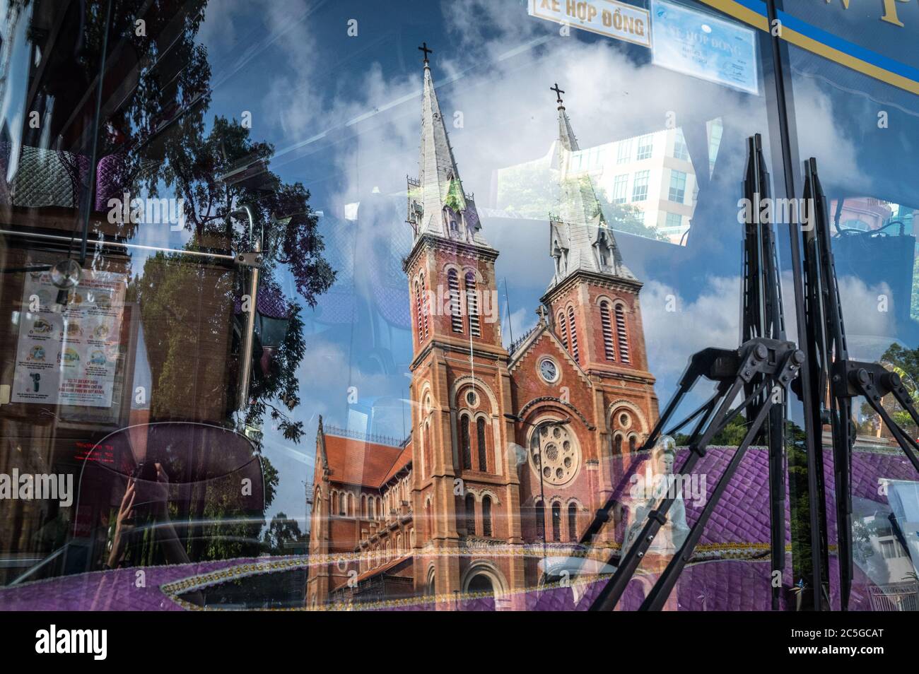 Notre-Dame Cathedral Basilica of Saigon reflected through the windshield of a bus, Ho Chi Minh City, Vietnam Stock Photo