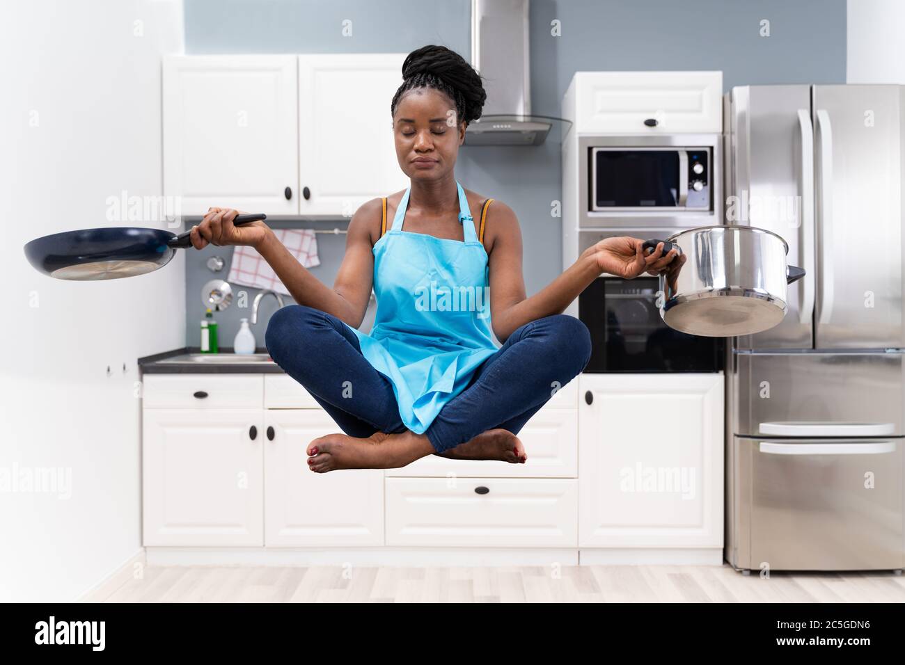 Stressed African Housewife Woman Meditating In Kitchen Stock Photo - Alamy