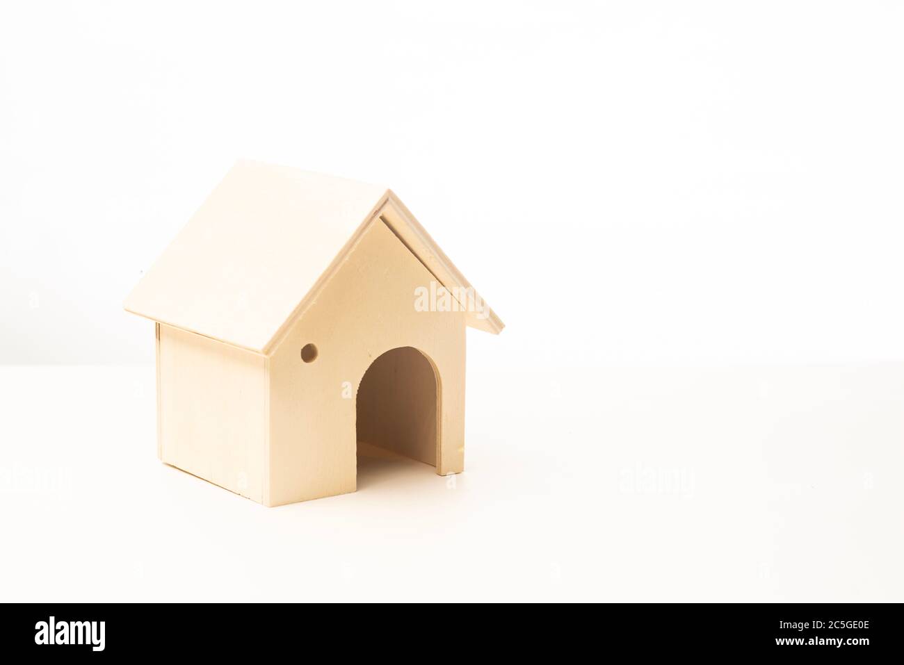 Miniature wooden house isolated against white background Stock Photo ...