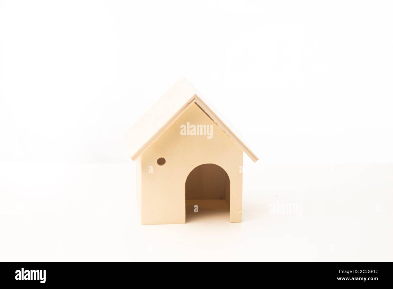 Miniature wooden house isolated against white background Stock Photo ...
