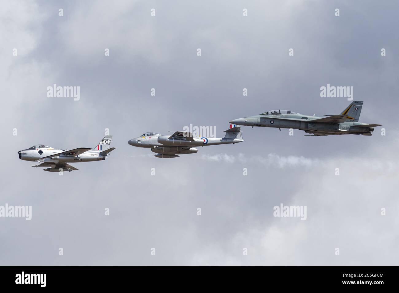 Former Royal Australian Air Force Commonwealth Aircraft Corporation CA-27 Sabre (F-86 Sabre) jet aircraft leading a Gloster Meteor and an RAAF F/A-18 Stock Photo